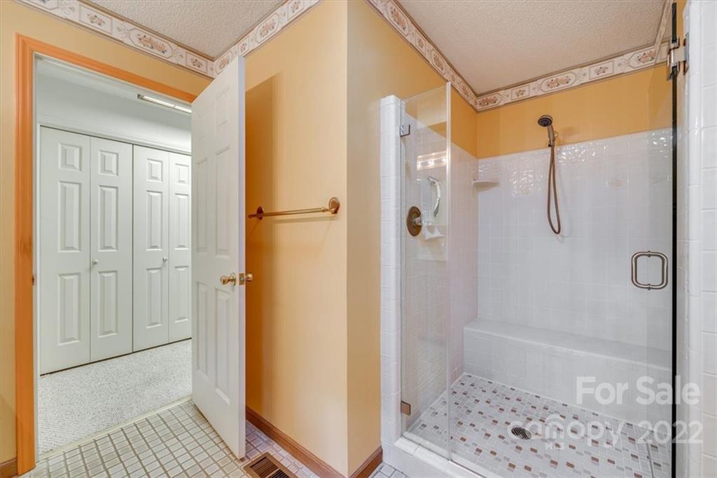 6036 Agate Court Tega Cay, SC 29708 - Photo 18 of 44 a bathroom with a shower and a glass door