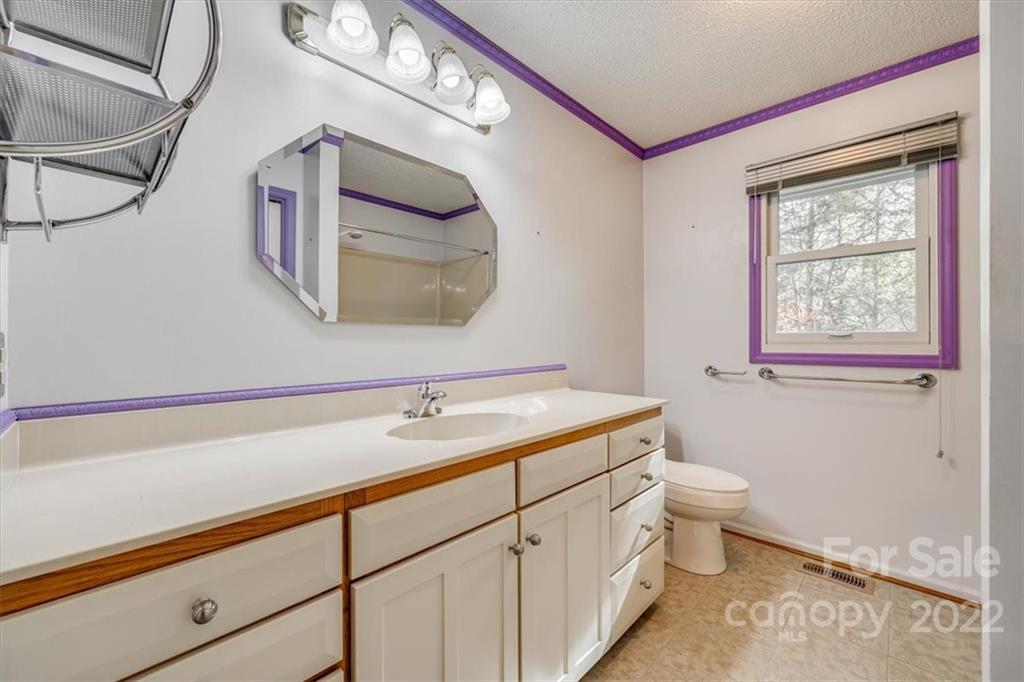 6036 Agate Court Tega Cay, SC 29708 - Photo 21 of 44 a bathroom with a toilet sink and mirror