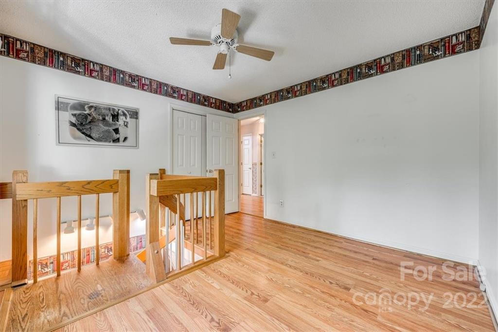 6036 Agate Court Tega Cay, SC 29708 - Photo 23 of 44 a view of a hallway with wooden floor