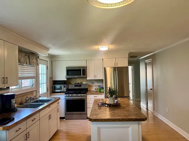 a kitchen with sink a stove and refrigerator
