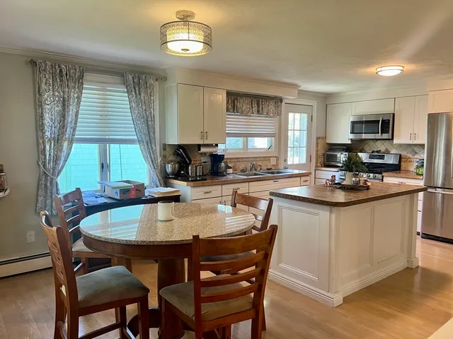 a kitchen with a dining table and chairs
