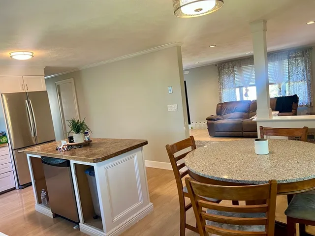 a dining room with furniture and wooden floor