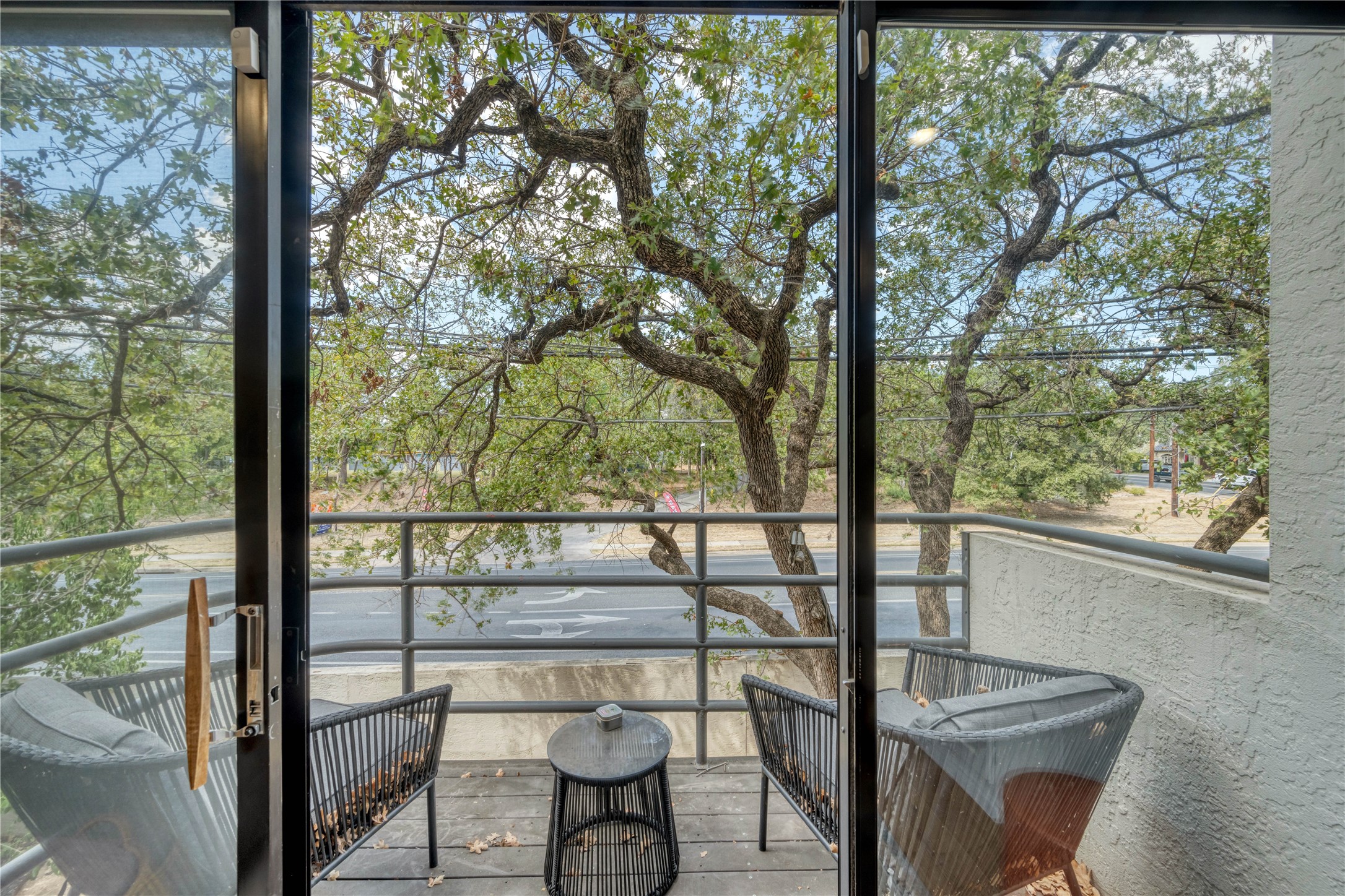 2605 Enfield Road, Unit 221 Austin, TX 78703 - Photo 12 of 30 Balcony off living roon has view across Exposition of trees bordering the West Austin Youth Association.