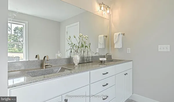 a close view of two sink and a mirror in a bathroom