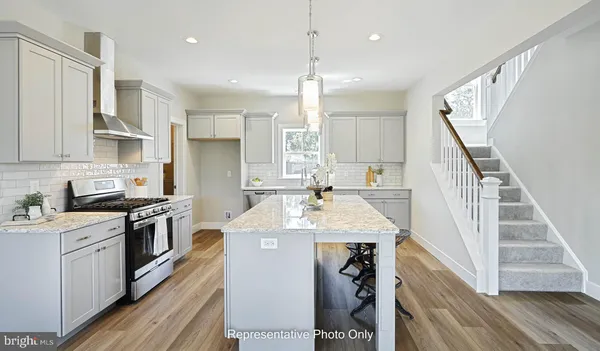 a kitchen with a stove a sink and a refrigerator