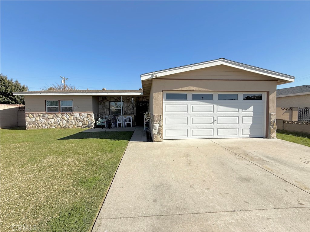 2309 Spinnaker Street Santa Ana, CA 92706 - Photo 2 of 9 a front view of a house with a yard and garage