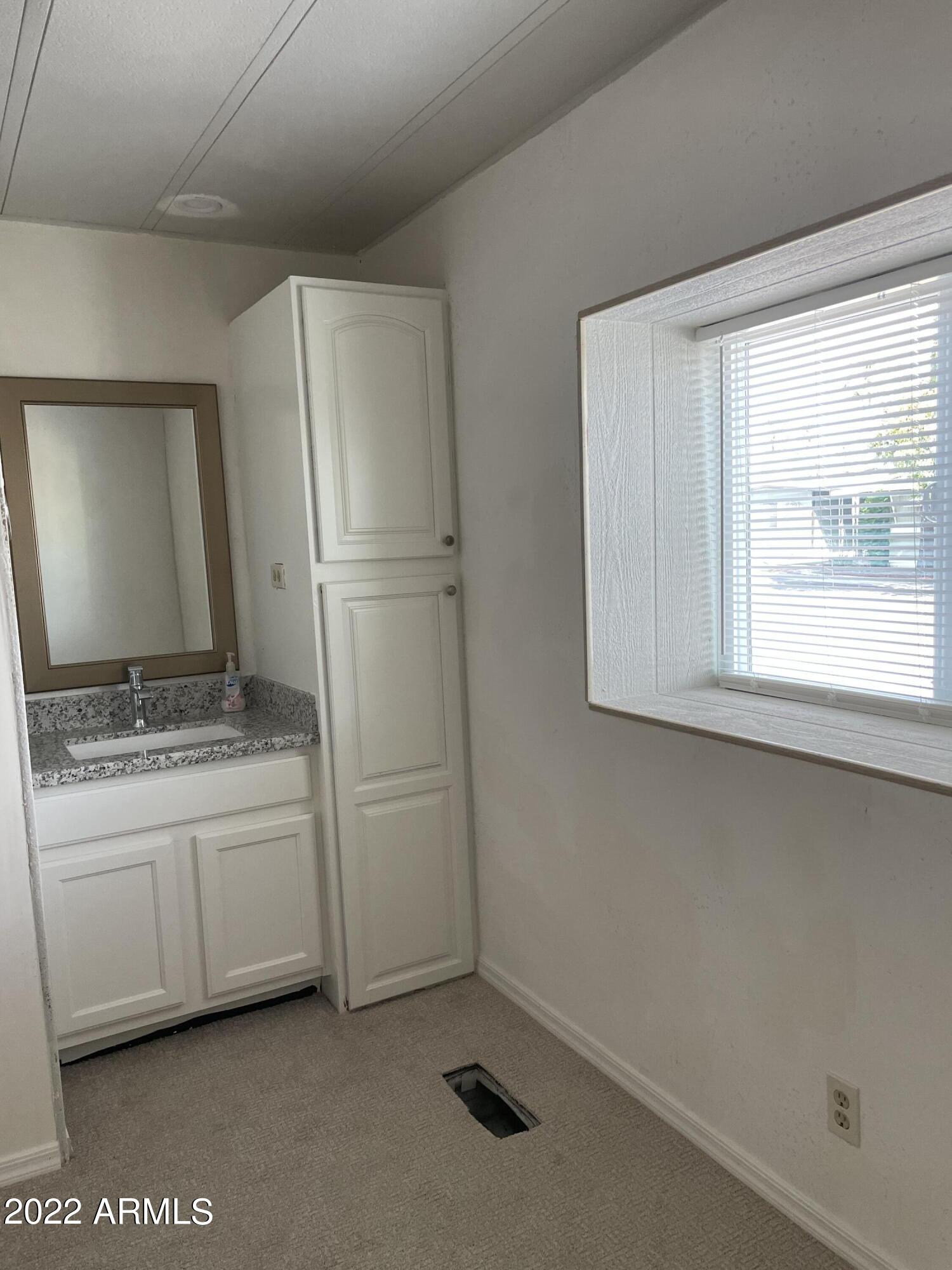 5201 West Camelback Road, Unit A7 Phoenix, AZ 85031 - Photo 16 of 22 a bathroom with a sink and a mirror