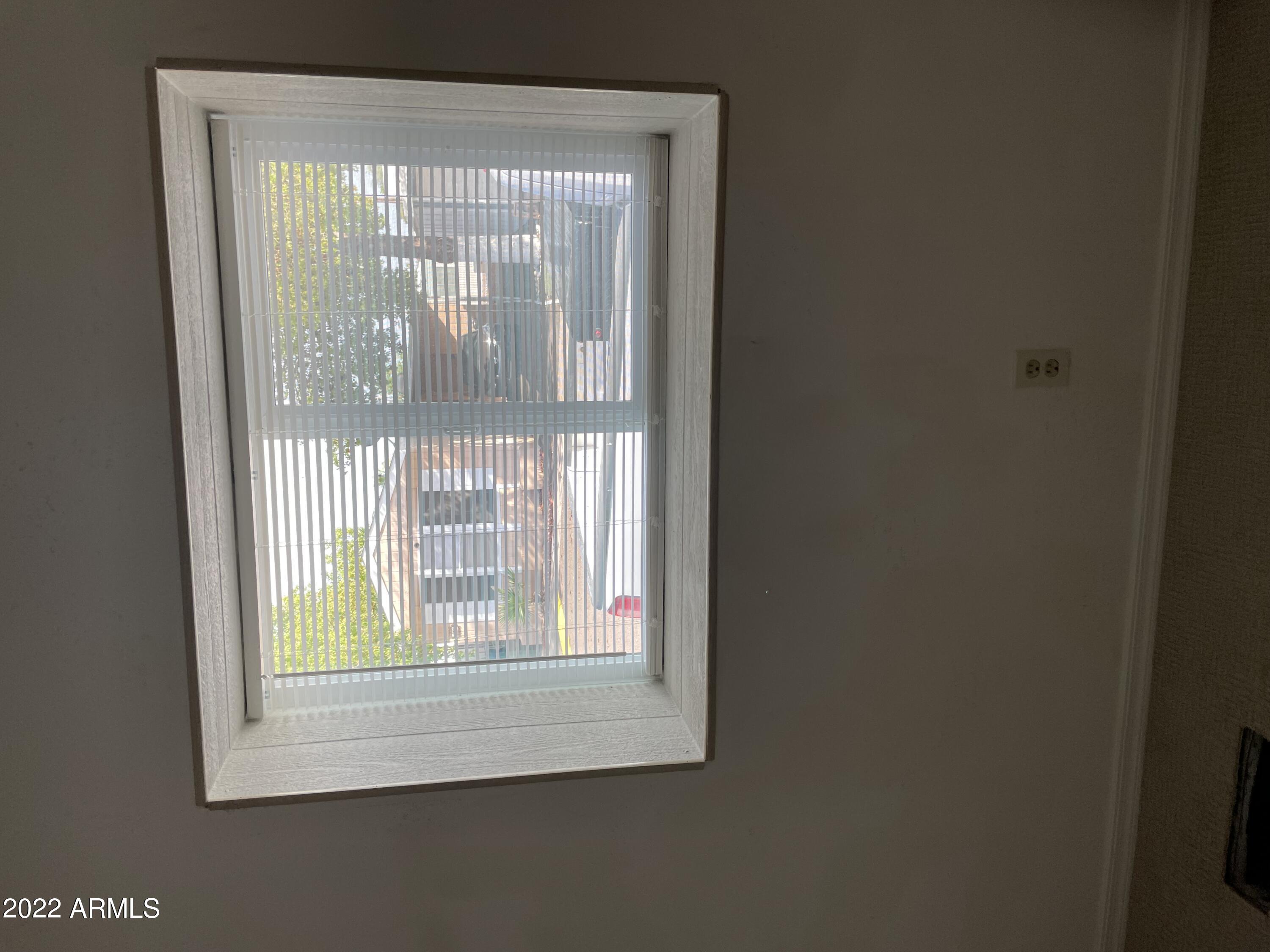 5201 West Camelback Road, Unit A7 Phoenix, AZ 85031 - Photo 19 of 22 a view of an empty room with a window