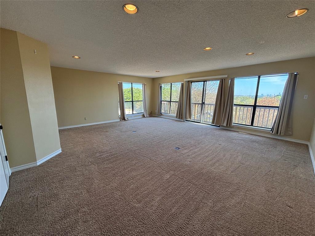 4702 Ranch View Road Fort Worth, TX 76109 - Photo 38 of 40 Expansive room with neutral carpeting, recessed ceiling lighting, and multiple windows providing ample natural light