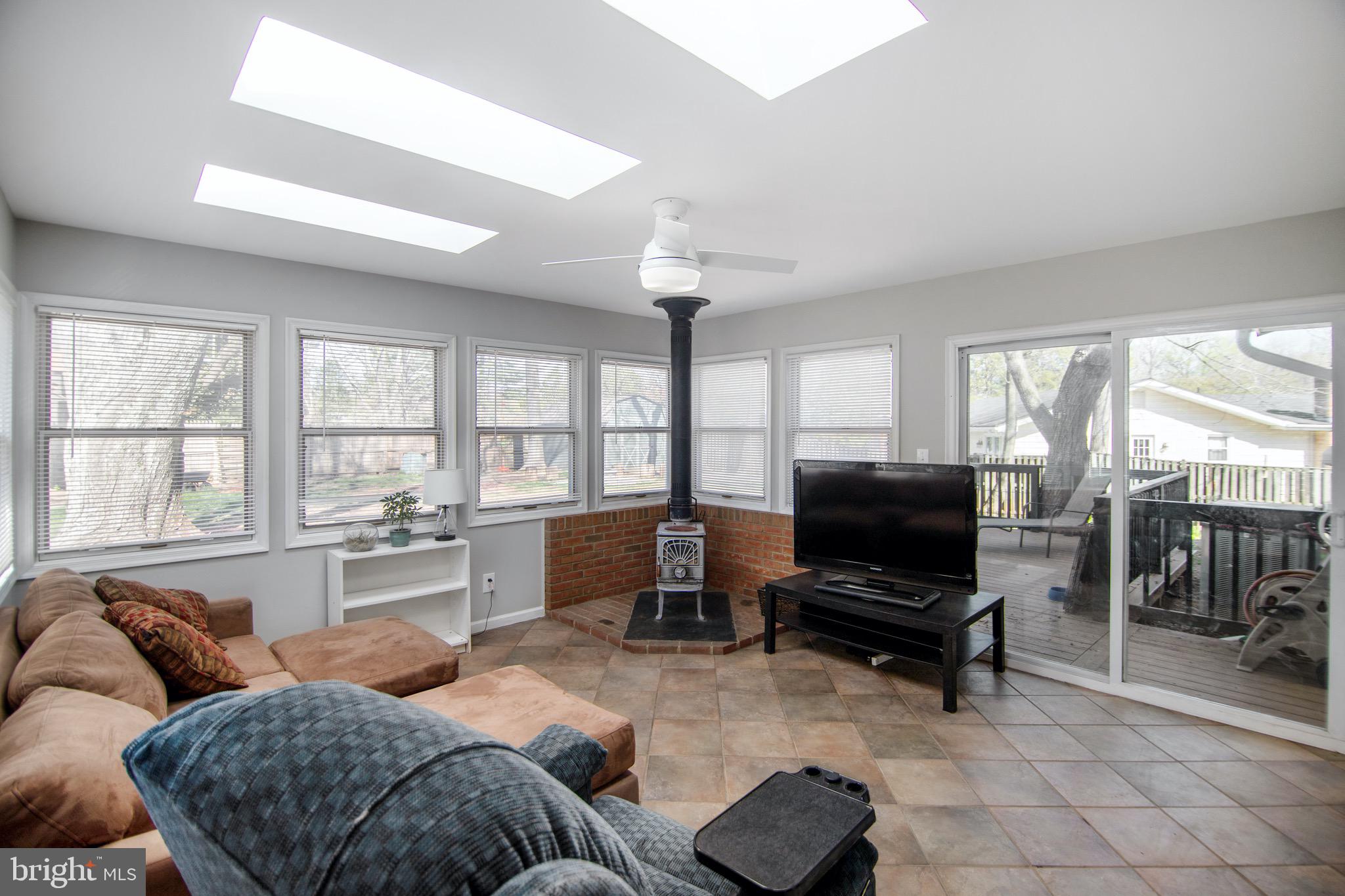 11324 Rambling Road Gaithersburg, MD 20879 - Photo 8 of 29 Sunroom with wood burning stove