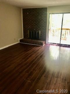 11048 Harrowfield Road Charlotte, NC 28226 - Photo 2 of 13 a view of a room with wooden floor and a floor to ceiling window