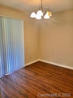 11048 Harrowfield Road Charlotte, NC 28226 - Photo 3 of 13 a view of a chandelier fan and wooden floor