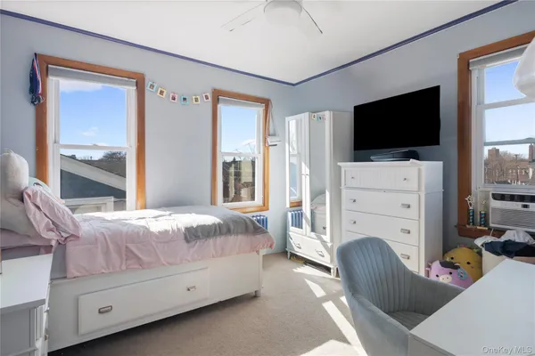 a bedroom with furniture and flat screen tv