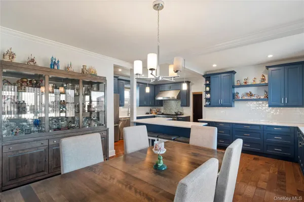 a kitchen with stainless steel appliances granite countertop a sink a stove and a wooden floors