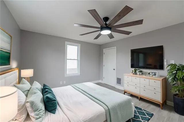 a bedroom with a bed and a flat screen tv