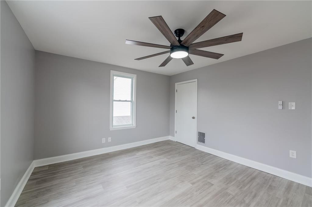 519 Lacock Street Rochester, PA 15074 - Photo 19 of 39 an empty room with wooden floor and windows
