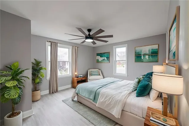 a bedroom with a bed and a potted plant