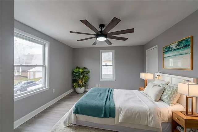 a bedroom with a bed and a large window