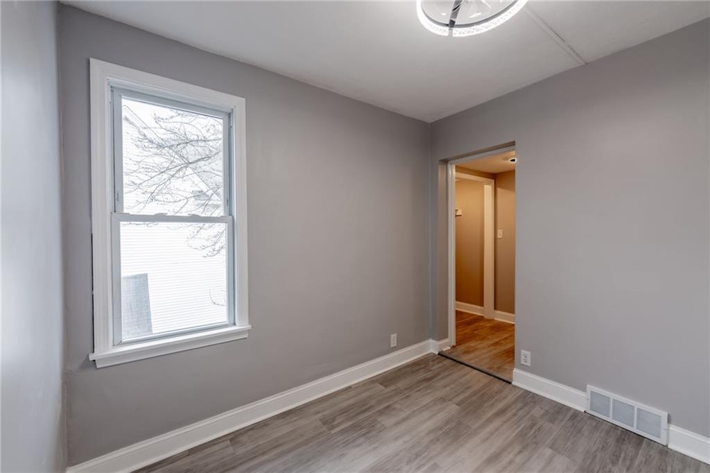 519 Lacock Street Rochester, PA 15074 - Photo 25 of 39 an empty room with wooden floor and windows