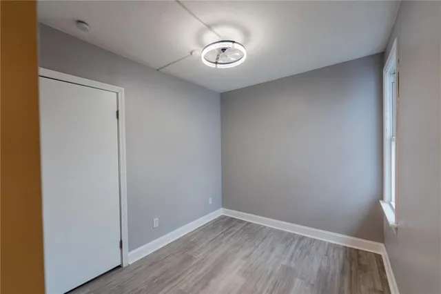 a view of empty room with wooden floor