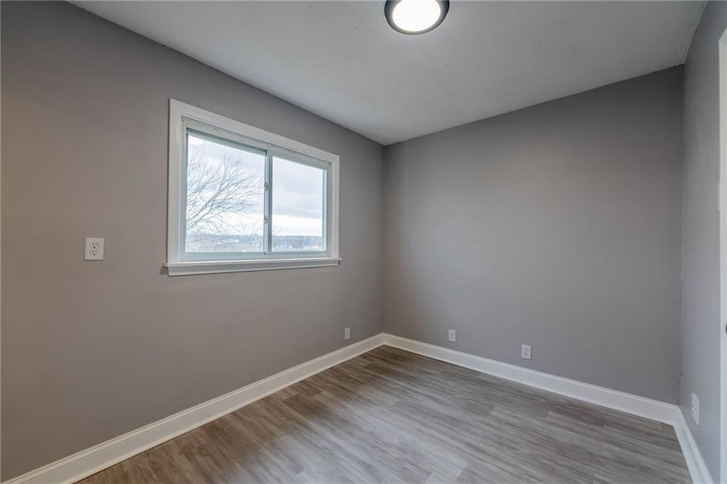519 Lacock Street Rochester, PA 15074 - Photo 29 of 39 an empty room with wooden floor and windows