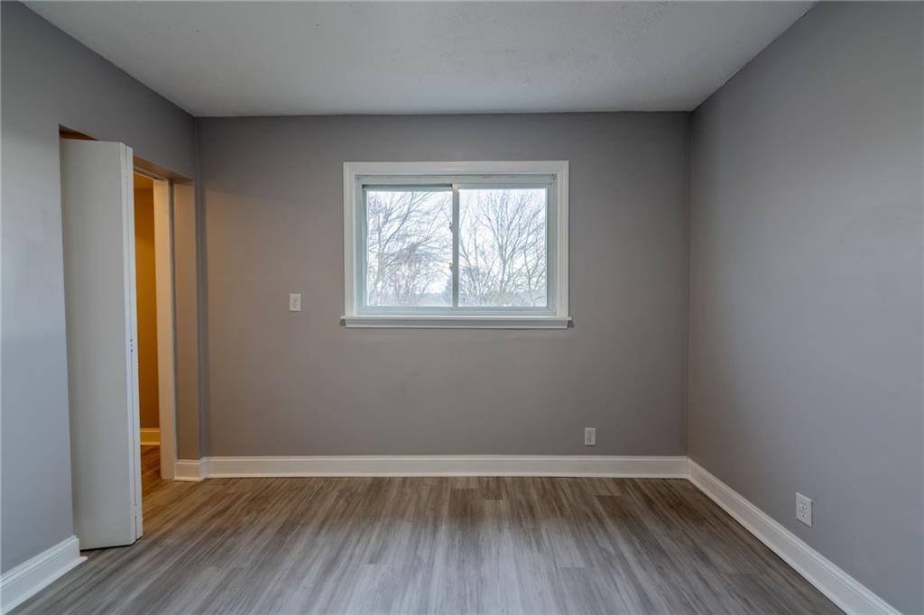 519 Lacock Street Rochester, PA 15074 - Photo 30 of 39 an empty room with wooden floor and windows