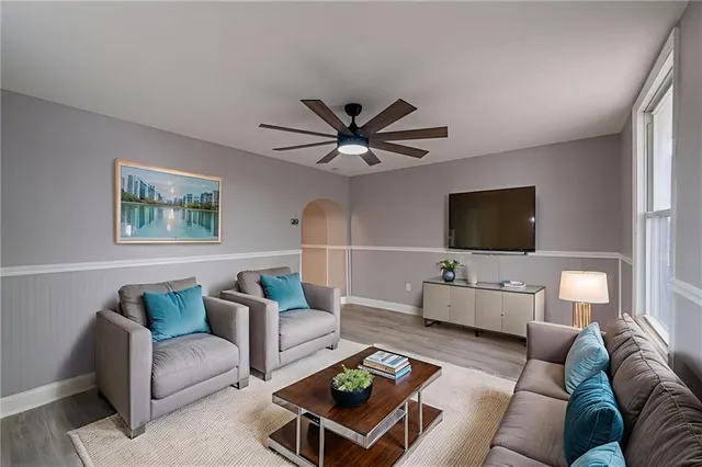 a living room with furniture and a flat screen tv