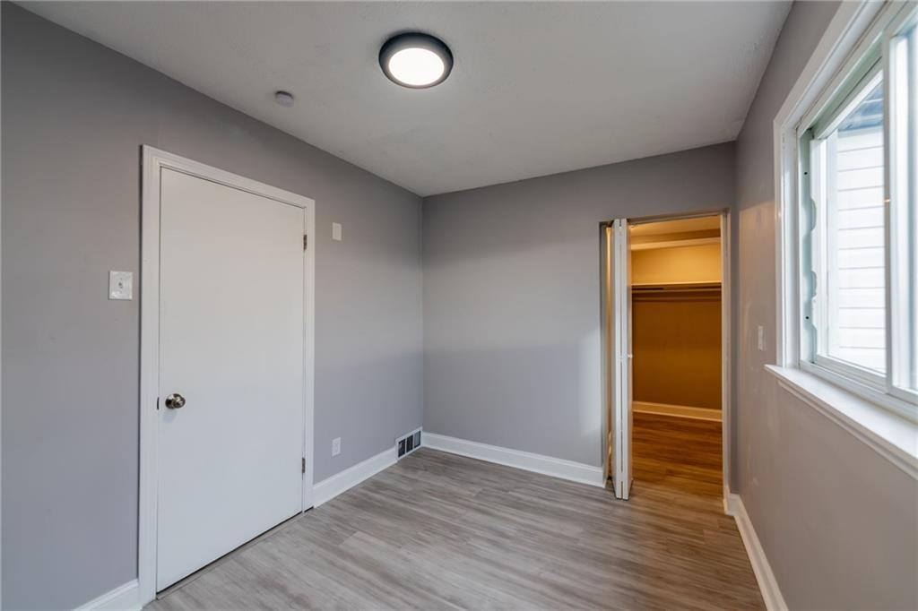 519 Lacock Street Rochester, PA 15074 - Photo 31 of 39 an empty room with wooden floor and windows