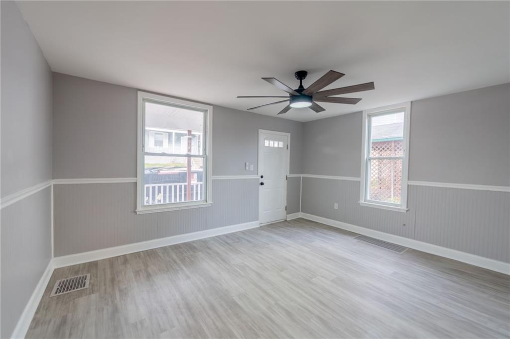 519 Lacock Street Rochester, PA 15074 - Photo 6 of 39 a view of an empty room with a window and a kitchen