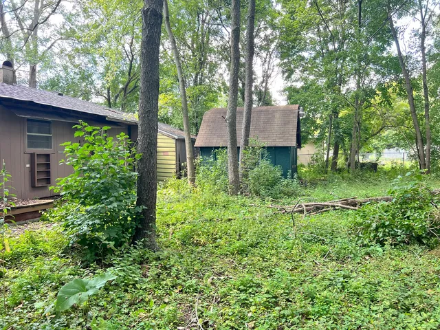 a view of house with lush green forest