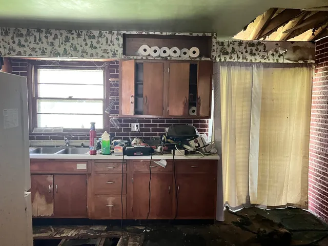 a kitchen with a sink and cabinets