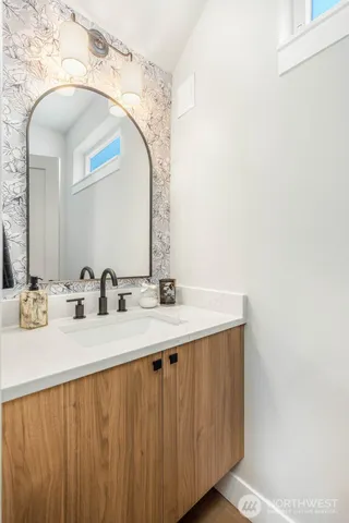 a bathroom with a double vanity sink and a mirror