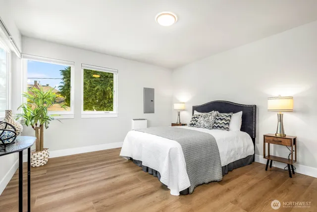 a bedroom with a bed and a potted plant