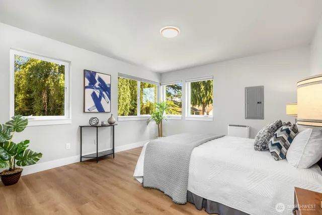 a bedroom with a bed and a potted plant
