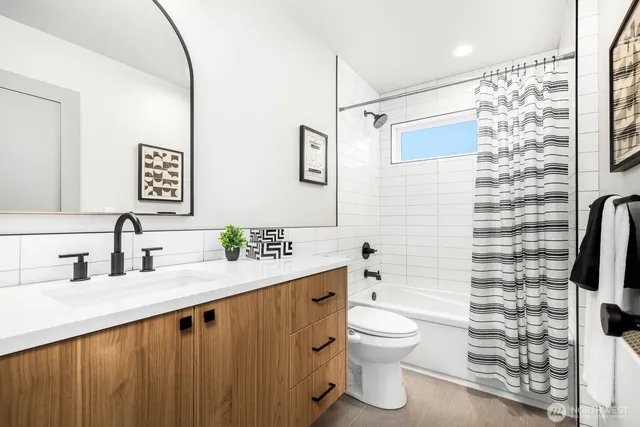 a bathroom with a granite countertop toilet sink and shower