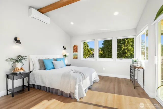 a bedroom with a bed and a large window