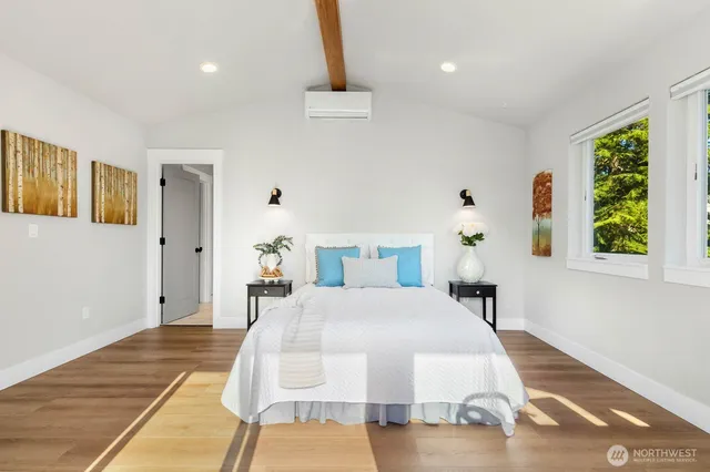 a bedroom with a bed dresser and a window