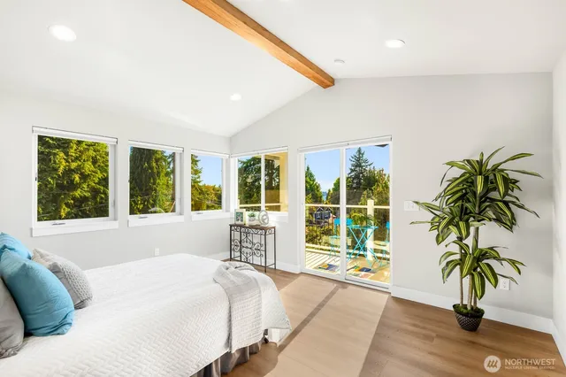 a bed sitting in a bedroom next to a large window