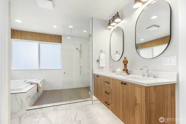 a bathroom with a double vanity sink mirror and toilet