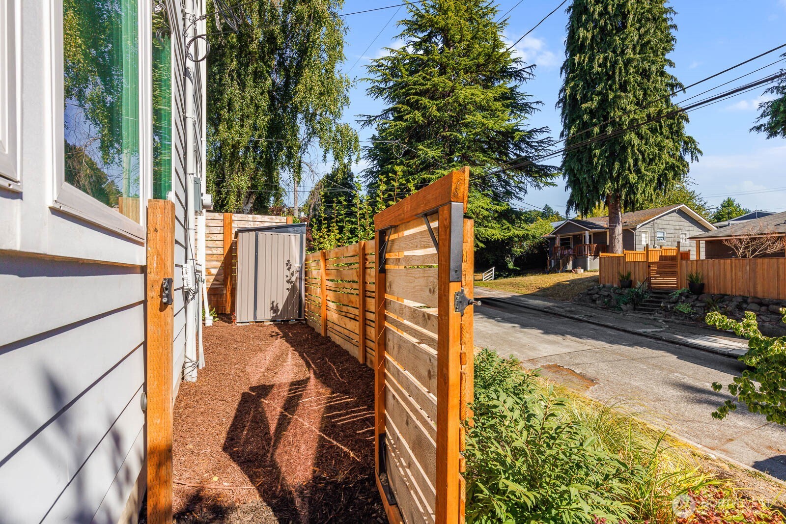 4326 Southwest Mills Street Seattle, WA 98136 - Photo 33 of 37 a view of balcony with wooden floor and fence and a potted plant