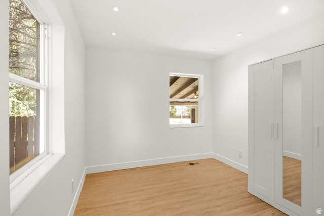 1187 East Ridgedale Circle Millcreek, UT 84106 - Photo 15 of 49 White-painted interior room featuring recessed lighting, light wood-finish flooring, and white baseboards