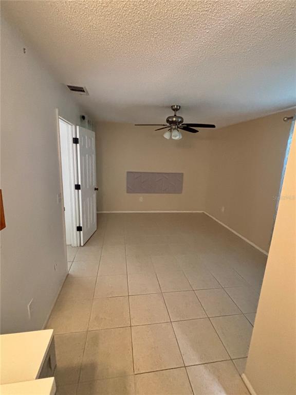 13100 South McCall Road, Unit 111 Port Charlotte, FL 33981 - Photo 8 of 10 an empty room with a fireplace and cabinet