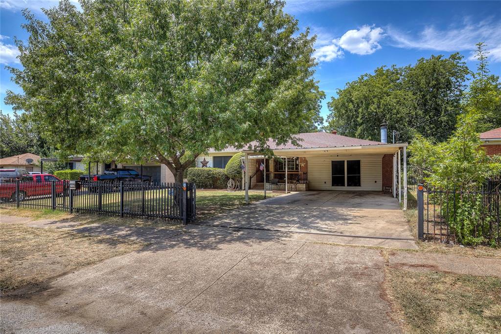 a view of a house with a yard and sitting area