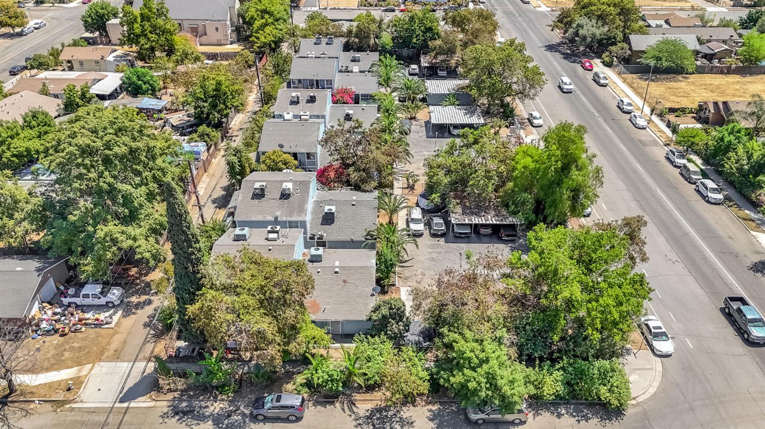 an aerial view of residential house with outdoor space and trees all around