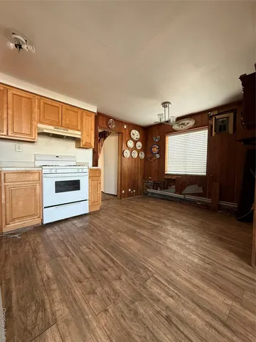 a view of a livingroom with a fireplace and window
