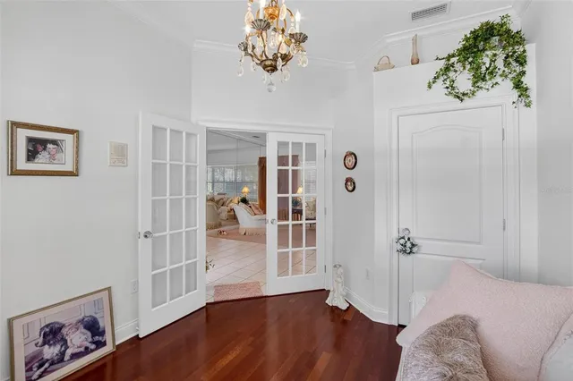 a view of a bedroom with wooden floor and hallway