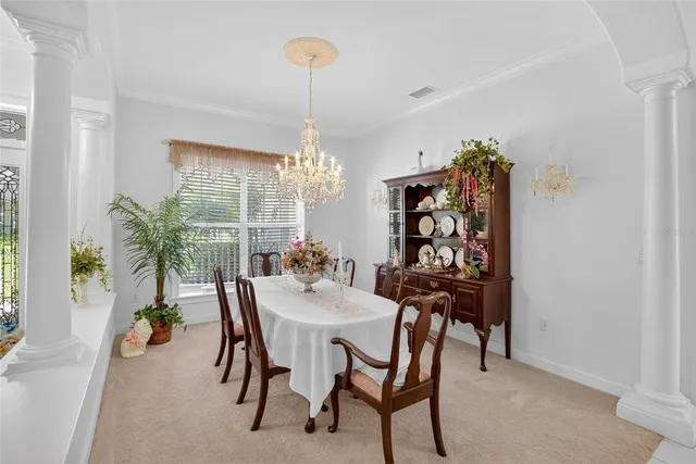 a view of a dining room with furniture and chandelier