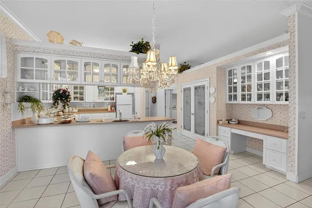 a dining room with furniture and chandelier