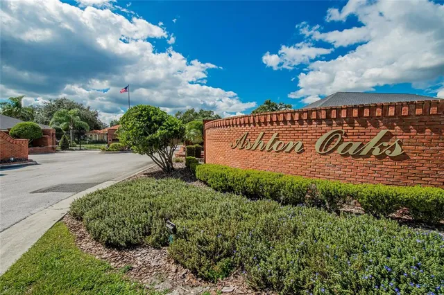 a sign that is sitting on a brick wall