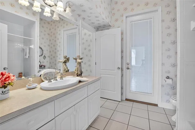a bathroom with a sink a vanity and a mirror